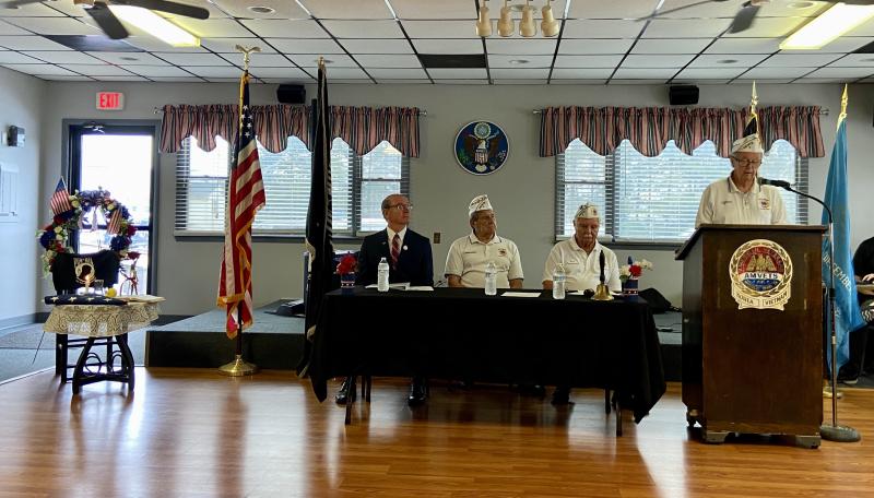 AMVETS Post 2 First Vice Commander Bill Willard recites the poem “I Am the Flag” while (l-r) Rep. Jeff Hilovsky, R-Long Neck; Commander Dave Heffline; and Past Commander Tom Jones listen.